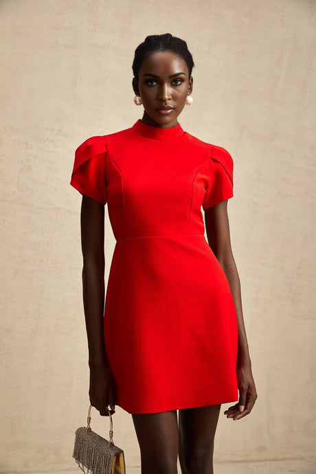 A short red mini dress with petal sleeves a cut out design and a bow detail