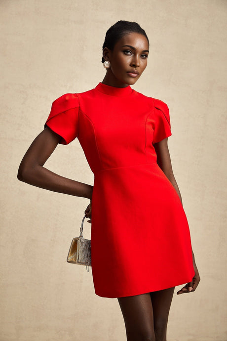 A short red mini dress with petal sleeves and a cutout design featuring a bow detail