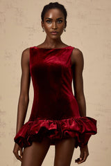 A short red velvet dress with a peplum hem detail and mini length perfect for evening wear