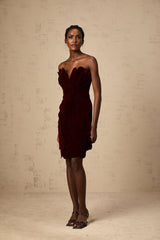 A short red velvet mini dress with floral appliques featuring a fitted silhouette and feminine design