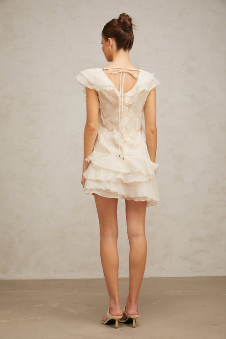 A short ruffled mini dress with layered faux flower details and a feminine silhouette