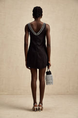 A short satin mini dress in a light color adorned with crystal embellishments elegant cocktail attire with a feminine silhouette