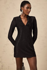 A short shimmering mini dress with a deep V neckline adorned with studs and embellishments