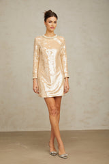 A short sleeveless mini dress in neutral tones adorned with faux pearls and sequins featuring a simple silhouette and elegant embellishments