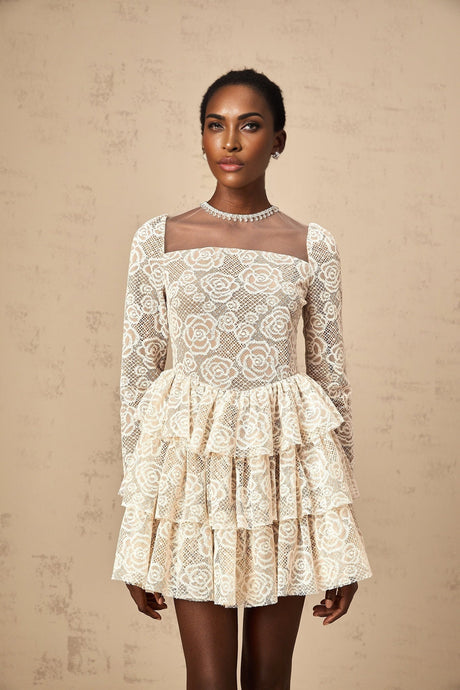 A short sleeveless mini dress in neutral tones featuring delicate floral embroidery throughout the fabric