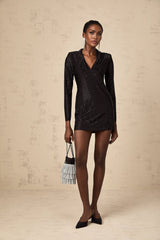 A short sleeveless mini dress with a deep plunging V neckline adorned with studs and embellishments featuring a fitted silhouette in a dark color