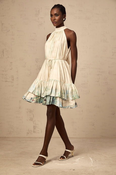 A short sleeveless mini dress with a layered design featuring a delicate pattern print in multiple colors and a flowy silhouette