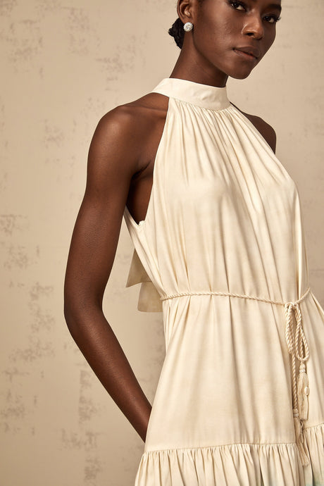 A short sleeveless mini dress with a layered design featuring a mix of floral and geometric patterns in multiple colors