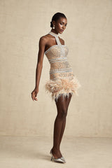 A short sleeveless mini dress with crystal embellishments and feather trim detailing along the hemline