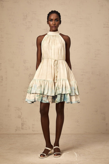 A short sleeveless mini dress with layered ruffles featuring a delicate floral pattern print in light colors