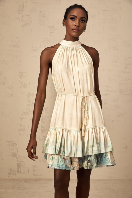 A short sleeveless mini dress with multiple layers featuring a mixed pattern print in various colors and designs