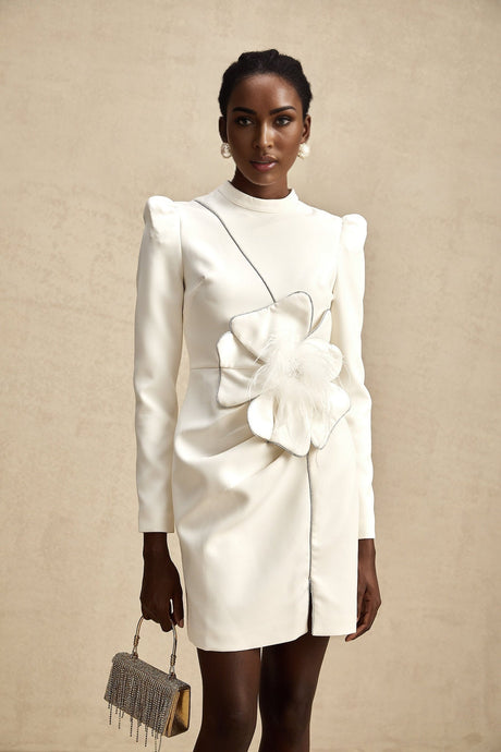 A short sleeveless minidress with decorative artificial flowers attached to the fabric