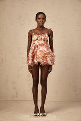 A short tiered mini dress with a strawberry print pattern covering the fabric The dress features a feminine design with ruffled layers and a summery look