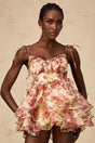 A short tiered mini dress with a vibrant strawberry print pattern featuring a red and green color scheme on a light background
