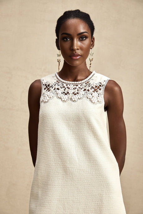 A short tweed mini dress with embroidery details and cut out sections featuring a feminine design in Beatrice style