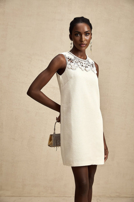 A short tweed mini dress with embroidery details and cut out sections featuring a stylish Beatrice design