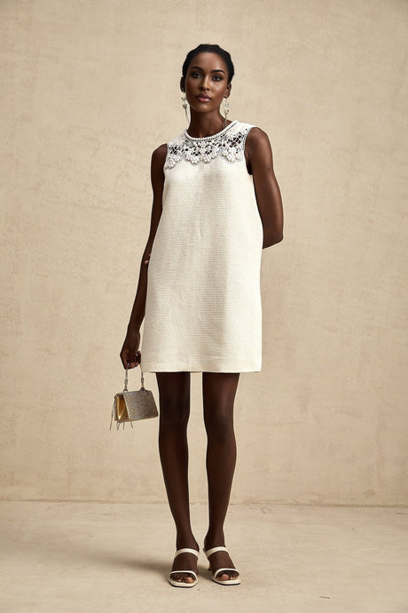 A short tweed mini dress with embroidery details and cut out sections