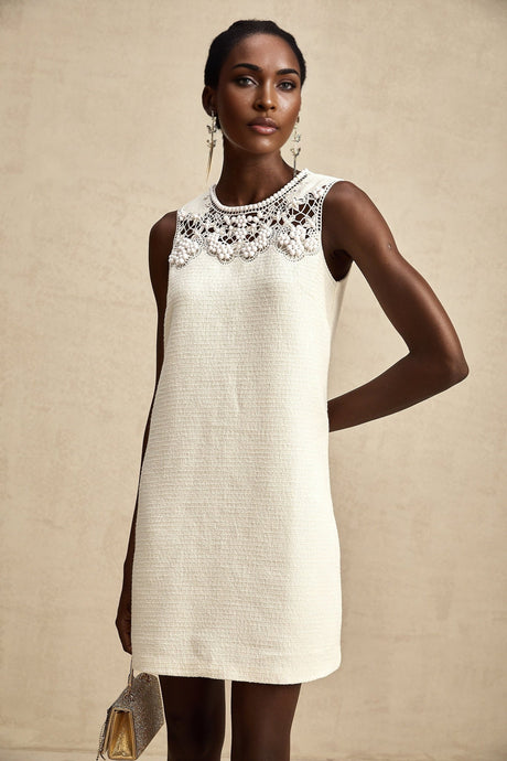 A short tweed mini dress with embroidery details and cut out sections