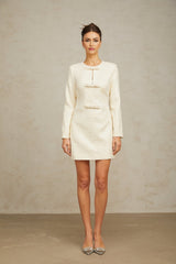 A short white dress made of tweed fabric embellished with sparkling sequins featuring a classic mini length design