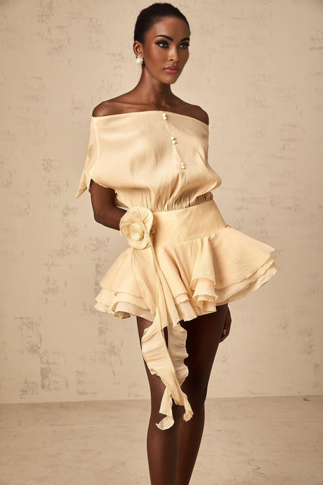 A short white dress with floral appliques and ruffled hem featuring a flounced skirt design named Amelie