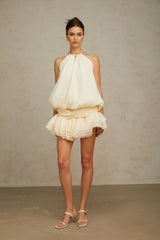 A short white halterneck mini dress adorned with faux pearls named Berenice