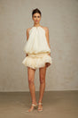 A short white halterneck mini dress adorned with faux pearls named Berenice
