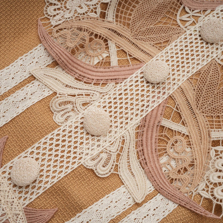 A short white lace dress with a peplum waist and cut out details featuring a fitted bodice and flared skirt
