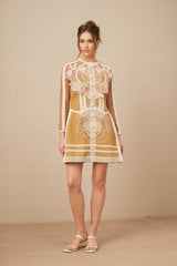 A short white lace dress with a peplum waist and cutout details featuring a fitted bodice and flared skirt