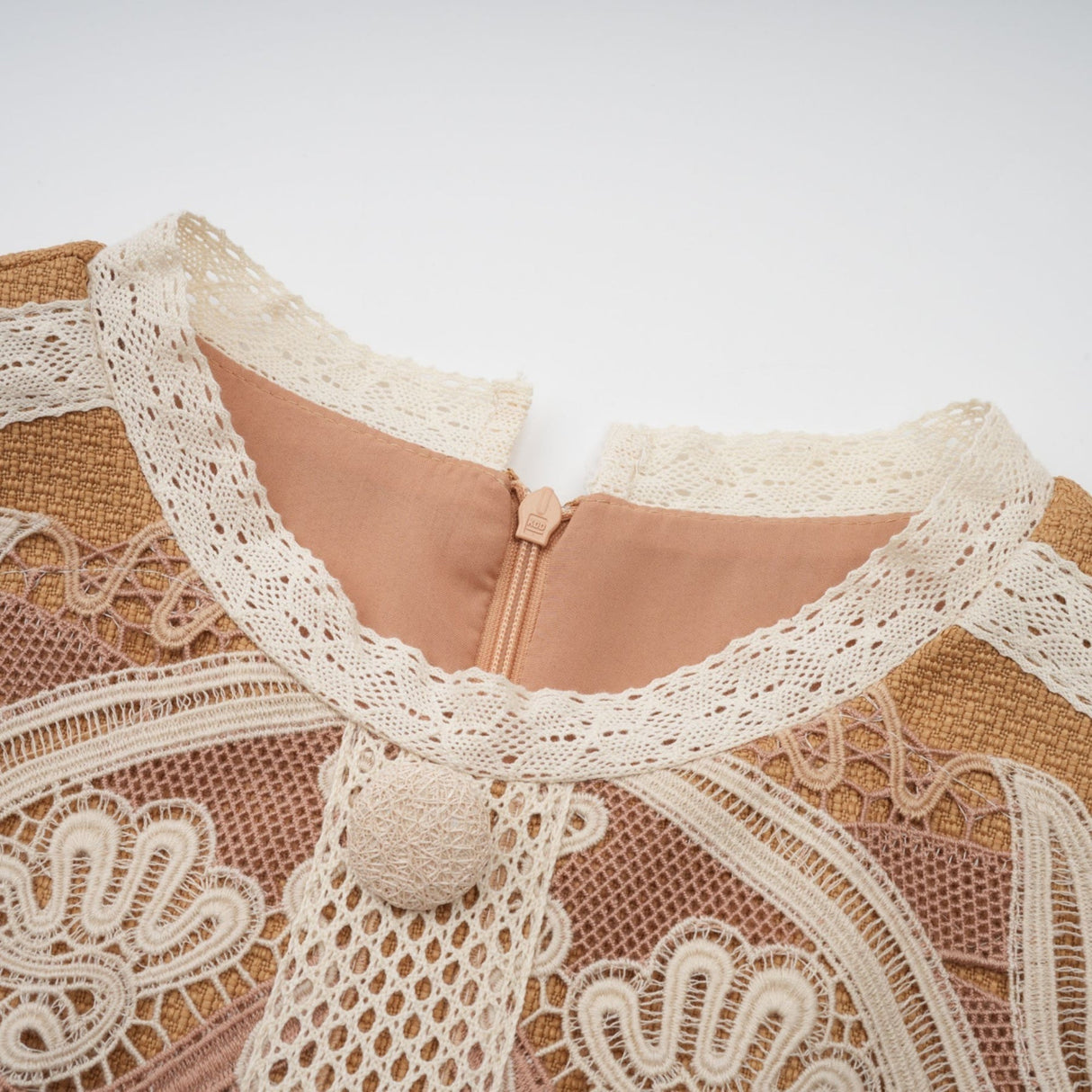 A short white lace dress with a peplum waist and cutout details featuring a fitted bodice and flared skirt