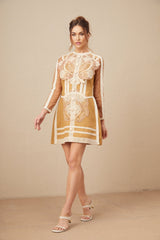 A short white lace dress with a peplum waist and cutout details featuring a fitted bodice and flared skirt