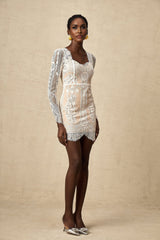 A short white lace mini dress with scalloped hem and delicate floral pattern