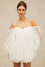 A short white layered dress with a puffy tulle skirt and bubblelike texture worn by a model against a plain background