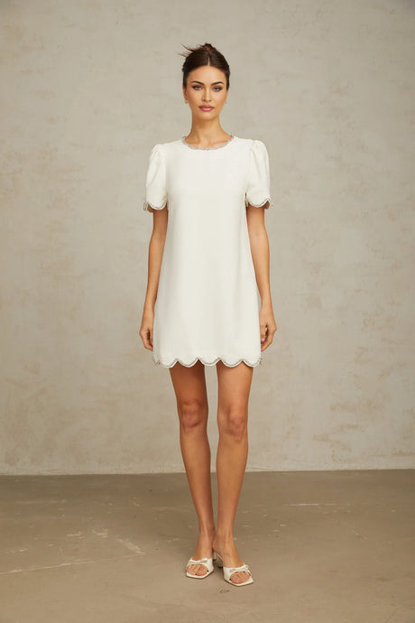 A short white mini dress adorned with crystal embellishments featuring a feminine silhouette and delicate detailing named Berenice