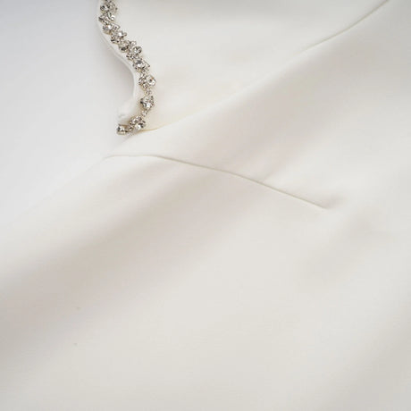A short white mini dress adorned with crystal embellishments named Berenice