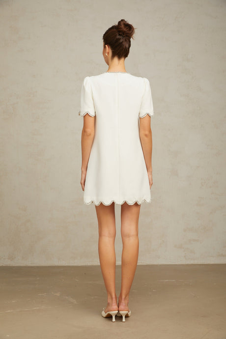A short white mini dress adorned with crystal embellishments named Berenice