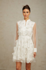A short white mini dress with 3D floral petal details made of tulle fabric named Camille