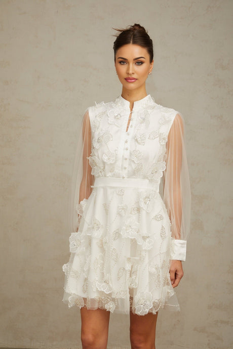 A short white mini dress with 3D floral petal details made of tulle fabric named Camille