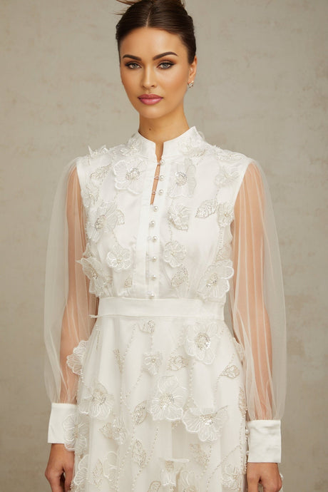 A short white mini dress with 3D floral petal details made of tulle fabric named Camille
