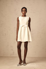 A short white mini dress with a bowknot embellishment named Isabelle
