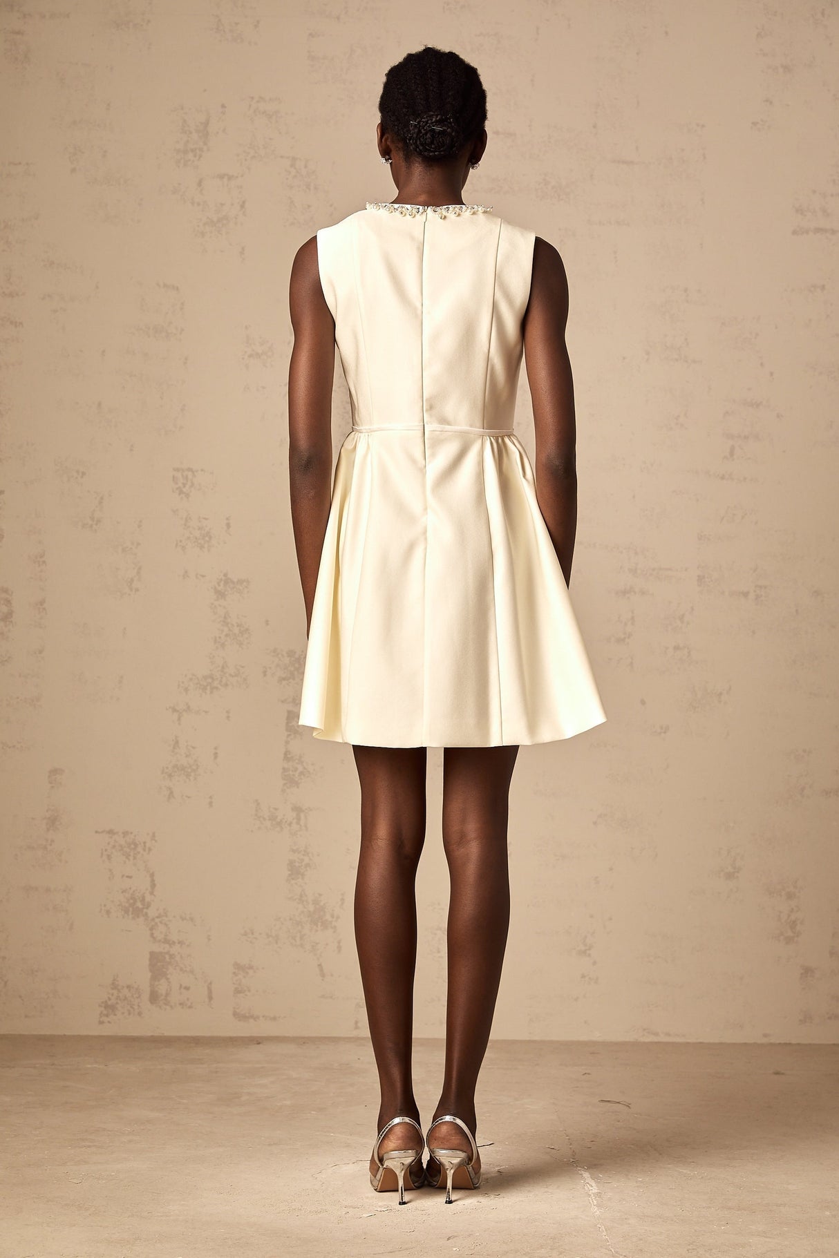A short white mini dress with a bowknot embellishment named Isabelle