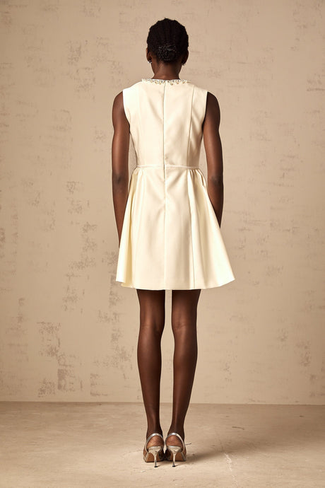 A short white mini dress with a bowknot embellishment named Isabelle
