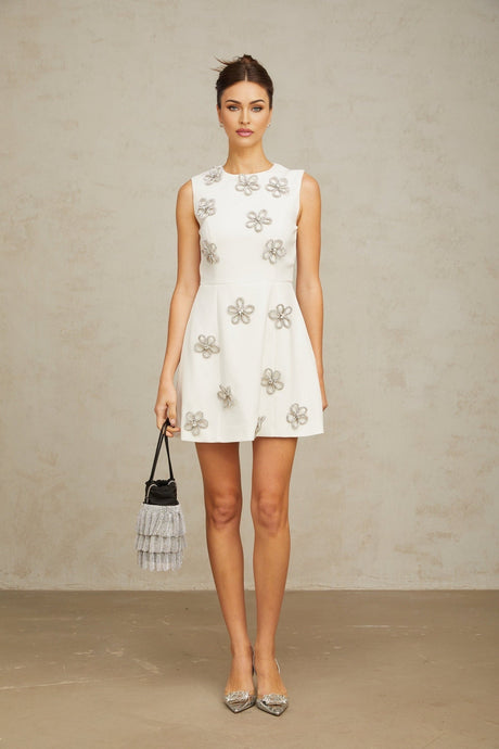 A short white mini dress with a floral pattern made of crystal embellishments adorning the fabric named Coralie
