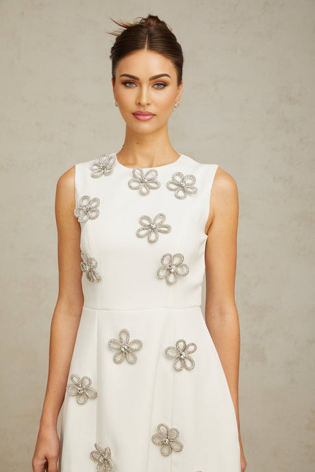 A short white mini dress with a floral pattern made of crystal embellishments covering the fabric named Coralie