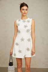 A short white mini dress with a floral pattern made of crystal embellishments featuring a delicate Coralie design