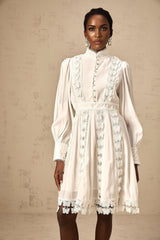 A short white mini dress with butterfly appliques decorating the fabric