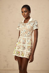 A short white mini dress with colorful floral embroidery featuring a feminine silhouette and delicate Françoise style design