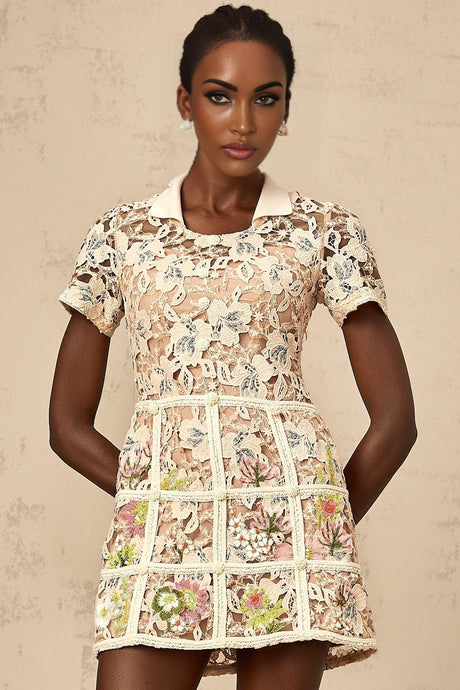 A short white mini dress with colorful floral embroidery pattern featuring a fitted bodice and flared skirt