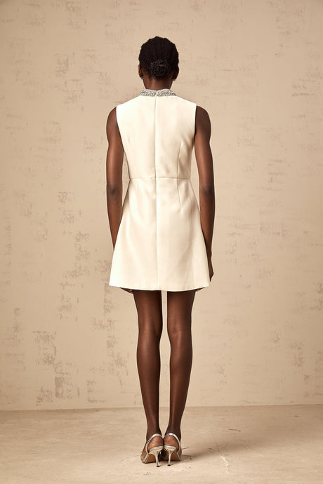 A short white mini dress with crystal embellishments adorning the fabric named Babette