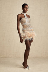 A short white mini dress with crystal embellishments and feather trim along the hem and neckline