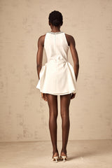 A short white mini dress with crystal embellishments and layered design featuring Denise style